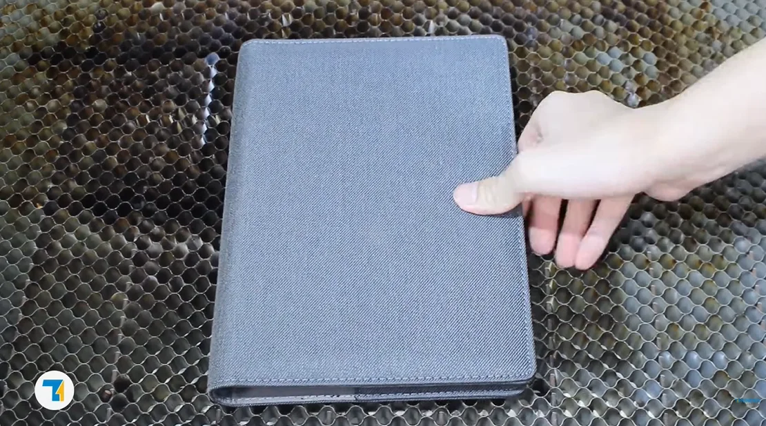 put the fabric notebook on the laser bed.webp